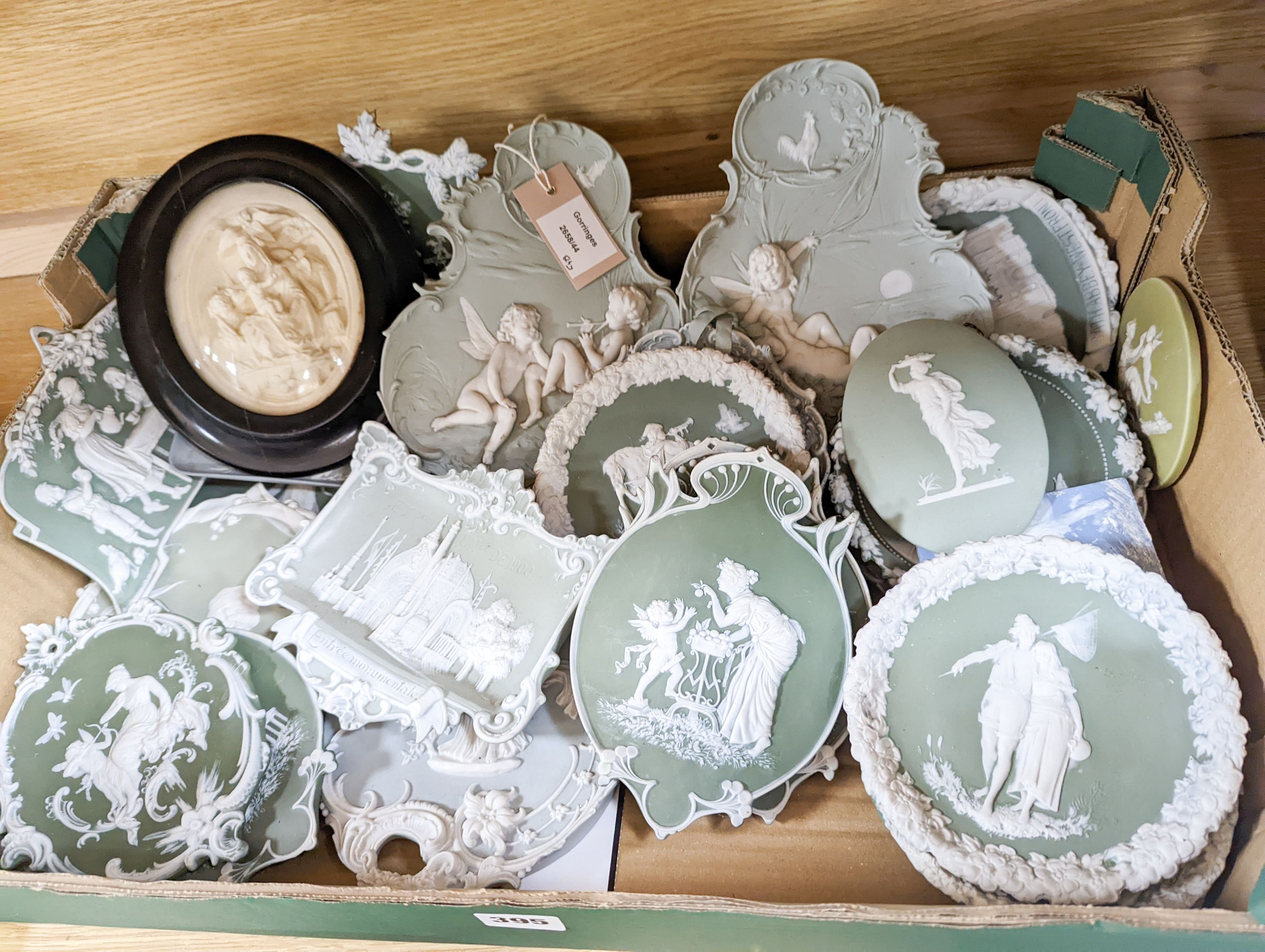 A collection of French bisque plaques, largest 24.5cm and two faux ivory reliefs